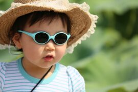 Child wearing sunglasses and sun hat