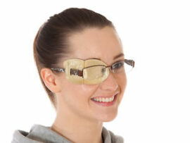 Woman wearing glasses with eye patch