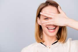 Woman with hand over eye