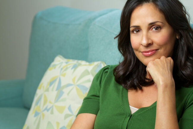 Middle-aged woman sitting on couch