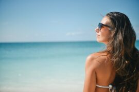 Woman wearing sunglasses on a beach